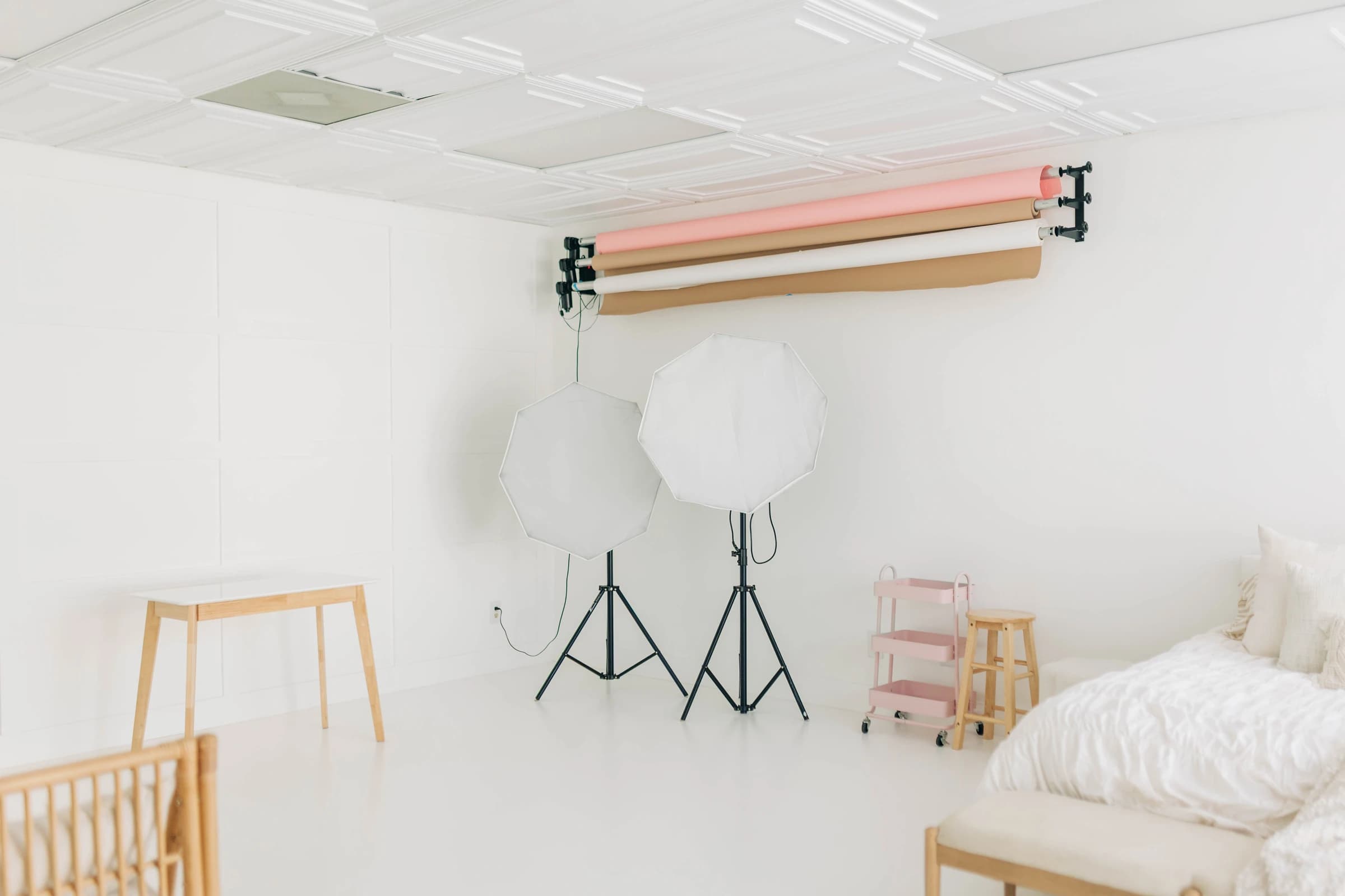 Studio A's stool and styling cart beside the backdrop wall