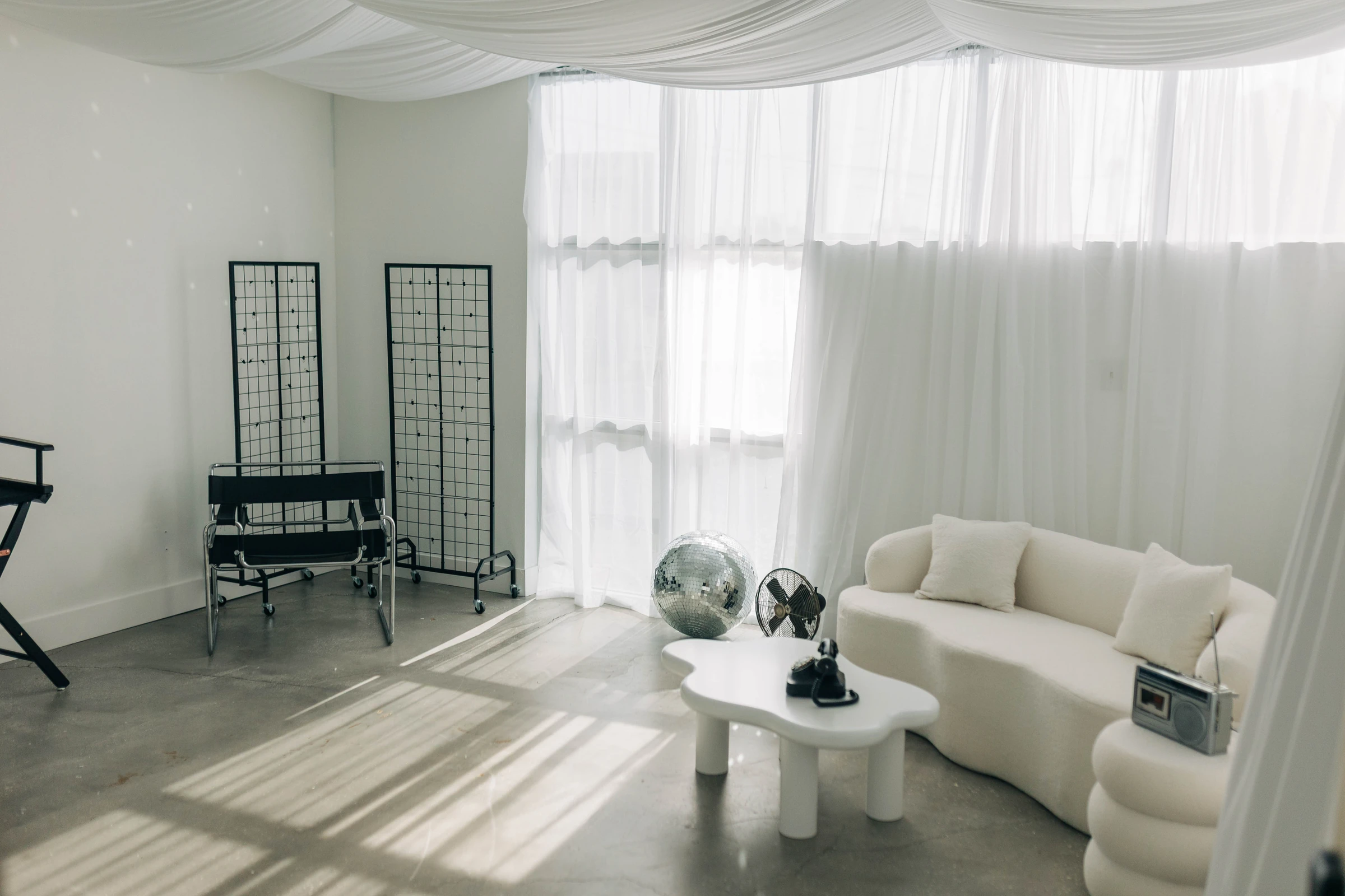 Studio B wide open, draped ceiling and morning light, ready for a crowd