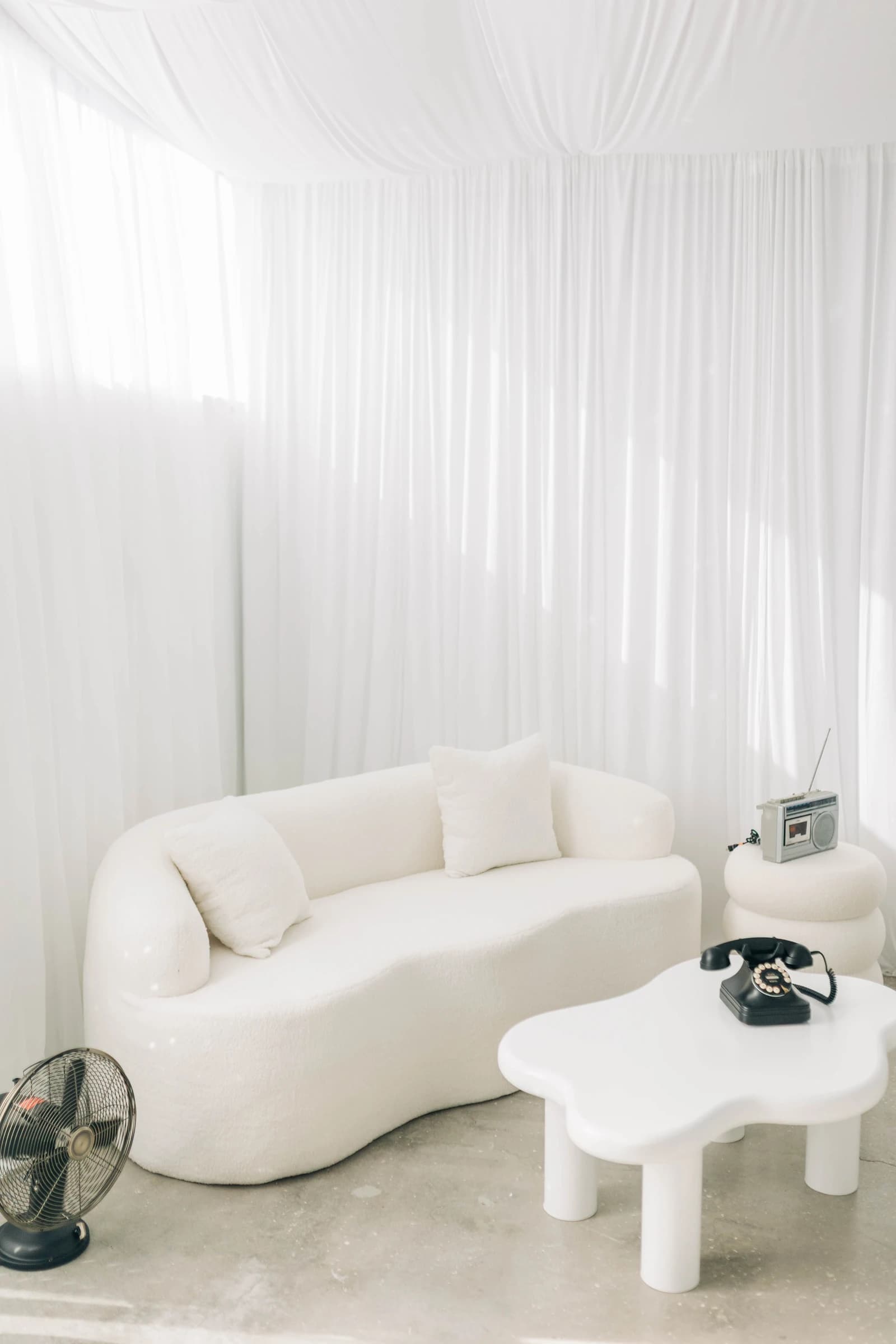Studio B's curved sofa and cloud table, styled with retro props